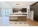 Spacious kitchen featuring stainless appliances, an island with a marble countertop, and dark cabinetry at 205 Red Cardinal Ct, Youngsville, NC 27596