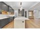 Kitchen featuring a large island, stainless steel appliances and dark cabinets at 205 Red Cardinal Ct, Youngsville, NC 27596