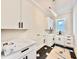 Bright laundry room featuring modern cabinetry, sleek hardware, and stylish hexagon tile flooring at 205 Red Cardinal Ct, Youngsville, NC 27596