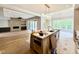 Open-concept kitchen and living room with an island, hardwood floors, and a fireplace feature wall at 205 Red Cardinal Ct, Youngsville, NC 27596