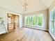 Bright living room with hardwood floors, modern lighting, and large windows offering picturesque views at 205 Red Cardinal Ct, Youngsville, NC 27596
