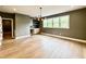 Bright living room with hardwood floors, stylish light fixture, and a modern dry bar for entertaining at 205 Red Cardinal Ct, Youngsville, NC 27596