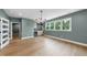 Open living room with bar area featuring a mini fridge, hardwood floors and lots of sunlight at 205 Red Cardinal Ct, Youngsville, NC 27596