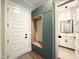 Inviting mudroom area with built-in storage and bench adjacent to the front door and bathroom at 205 Red Cardinal Ct, Youngsville, NC 27596