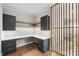 Office with wooden floors, modern cabinets, floating shelves and a view of the stairway at 205 Red Cardinal Ct, Youngsville, NC 27596