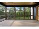 Screened porch with wood flooring and tongue and groove ceiling overlooks a wooded area at 205 Red Cardinal Ct, Youngsville, NC 27596
