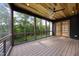 Screened porch with ceiling fan and access to the backyard; features tongue and groove ceiling at 205 Red Cardinal Ct, Youngsville, NC 27596