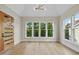 Bright, open room with large windows, wood floors and paneled door at 205 Red Cardinal Ct, Youngsville, NC 27596