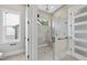Walk-in shower featuring glass enclosure, rain shower head, bench seating, and neutral colored tile surround at 205 Red Cardinal Ct, Youngsville, NC 27596