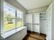 Bright walk-in closet with custom shelving and window offering natural light and neighborhood views at 205 Red Cardinal Ct, Youngsville, NC 27596