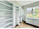 Bright walk-in closet with custom shelving and window offering natural light and neighborhood views at 205 Red Cardinal Ct, Youngsville, NC 27596
