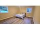 Cozy bedroom with two windows and wood look flooring at 7610 Buckhorn Rd, Hillsborough, NC 27278