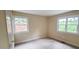 Bright bedroom with neutral walls and trim and large windows providing ample natural light at 7610 Buckhorn Rd, Hillsborough, NC 27278