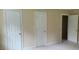 Bedroom featuring neutral walls, white trim, and closet doors leading to storage and additional spaces at 7610 Buckhorn Rd, Hillsborough, NC 27278