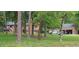Brick home with mature trees, a spacious yard, and work vehicles at 7610 Buckhorn Rd, Hillsborough, NC 27278