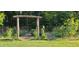 Fenced garden with a wooden trellis entrance with a field of blooming yellow sunflowers at 7610 Buckhorn Rd, Hillsborough, NC 27278