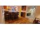 Eat-in kitchen with barstool seating, hardwood floors, and modern finishes at 7610 Buckhorn Rd, Hillsborough, NC 27278