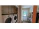 Convenient laundry room with washer, dryer, and storage cabinets at 7610 Buckhorn Rd, Hillsborough, NC 27278