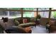 Relax in this sunroom featuring wicker furniture and views of the backyard at 7610 Buckhorn Rd, Hillsborough, NC 27278