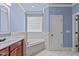Relaxing bathroom with corner tub and double vanity at 6720 Fawn Hoof Trl, Holly Springs, NC 27540
