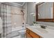 Bathroom includes a shower/tub combo, wood vanity, and neutral tile at 6720 Fawn Hoof Trl, Holly Springs, NC 27540