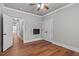 Bedroom with gray walls, wood floors, and access to hallway and another room at 6720 Fawn Hoof Trl, Holly Springs, NC 27540