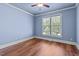 Light blue bedroom with wood floors and a ceiling fan at 6720 Fawn Hoof Trl, Holly Springs, NC 27540