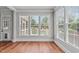 Breakfast nook with hardwood floors and large windows overlooking the backyard at 6720 Fawn Hoof Trl, Holly Springs, NC 27540