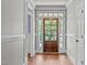 Bright entryway with hardwood floors and a wood door at 6720 Fawn Hoof Trl, Holly Springs, NC 27540