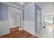 Hardwood floor hallway with blue walls and white trim at 6720 Fawn Hoof Trl, Holly Springs, NC 27540