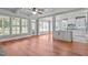 Bright kitchen boasts white cabinets, a peninsula, and blue glass tile backsplash at 6720 Fawn Hoof Trl, Holly Springs, NC 27540