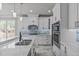 Modern kitchen with white cabinets, stainless steel appliances, and a large island at 6720 Fawn Hoof Trl, Holly Springs, NC 27540