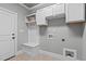Laundry room with white cabinets, bench, and built-in storage at 6720 Fawn Hoof Trl, Holly Springs, NC 27540