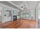 Bright living room with hardwood floors, fireplace, built-in shelving and access to backyard at 6720 Fawn Hoof Trl, Holly Springs, NC 27540