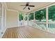 Spacious screened porch with wood flooring and ceiling fan at 6720 Fawn Hoof Trl, Holly Springs, NC 27540