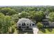 Expansive aerial view of a modern home surrounded by lush greenery and mature trees at 712 Daniels St, Raleigh, NC 27605