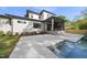 A well manicured backyard features a covered patio, swimming pool, and lush landscaping at 712 Daniels St, Raleigh, NC 27605