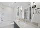 Bright bathroom featuring a shower-tub combo, a window, and a vanity with a modern sink at 712 Daniels St, Raleigh, NC 27605