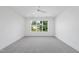 Bright, empty bedroom featuring a large window with pleasant neighborhood views and ceiling fan at 712 Daniels St, Raleigh, NC 27605