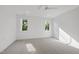 Spacious bedroom bathed in natural light with plush carpet, recessed lights, and large window at 712 Daniels St, Raleigh, NC 27605