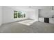 Spacious bonus room with a wet bar, carpet, large window, and ceiling fan at 712 Daniels St, Raleigh, NC 27605