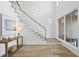 Open-concept foyer with staircase, chandelier lighting, and large windows for a bright feel at 712 Daniels St, Raleigh, NC 27605