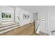 Bright hallway featuring hardwood floors, decorative wall art, and access to multiple rooms at 712 Daniels St, Raleigh, NC 27605