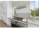 Contemporary kitchen with stainless steel range, custom hood, and white stone backsplash at 712 Daniels St, Raleigh, NC 27605