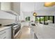 Bright kitchen with stainless steel range, marble countertops and large island with barstool seating at 712 Daniels St, Raleigh, NC 27605