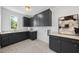 Well-organized laundry room with custom cabinetry, modern fixtures, and ample counter space at 712 Daniels St, Raleigh, NC 27605