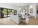 Spacious living room features a fireplace, modern light fixture, and sliding glass doors to the patio at 712 Daniels St, Raleigh, NC 27605