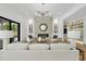 Spacious living room features a fireplace, modern light fixture, and sliding glass doors to the patio at 712 Daniels St, Raleigh, NC 27605