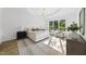 Bright primary bedroom features a sitting area and a large window with natural light at 712 Daniels St, Raleigh, NC 27605