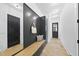 Mudroom with black accents, bench seating, storage cabinets, and modern decor at 712 Daniels St, Raleigh, NC 27605